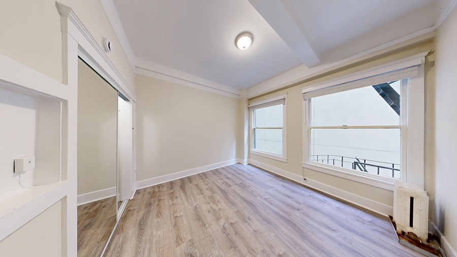 A room with a window and a door.